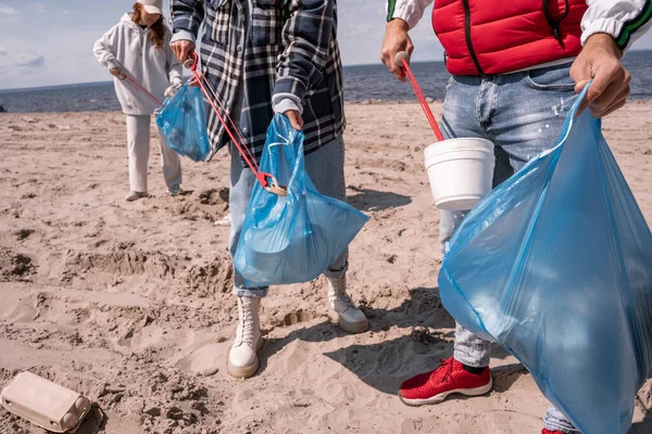 Volunteers collecting garbage in trash bags — Stock Photo