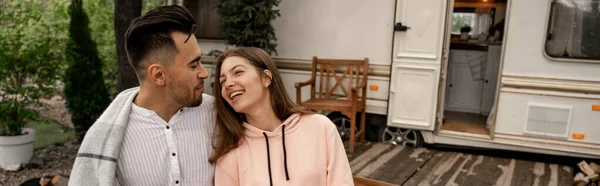 Happy young couple laughing near trailer outdoors, banner — Foto stock