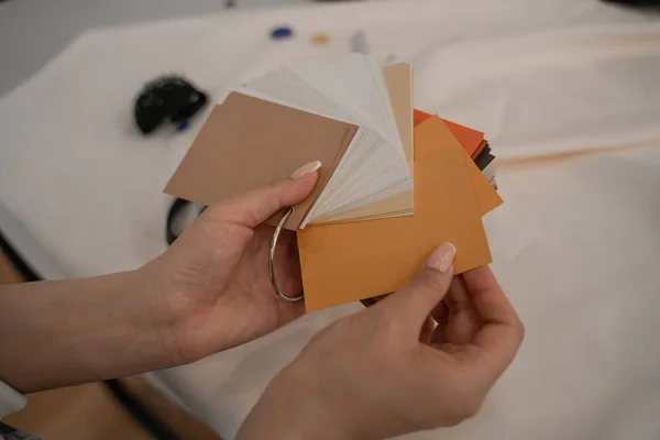 Cropped view of designer holding color swatches — Stock Photo