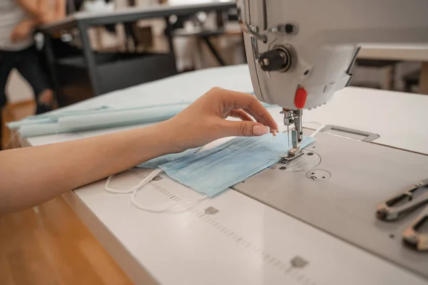 Cropped view of seamstress working with medical mask and sewing machine — Stock Photo