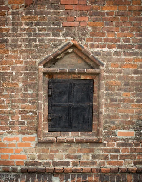 Old window in a brick wall, closed  metal shutters — Stock Photo, Image