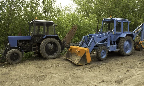 Two blue tractors — ストック写真