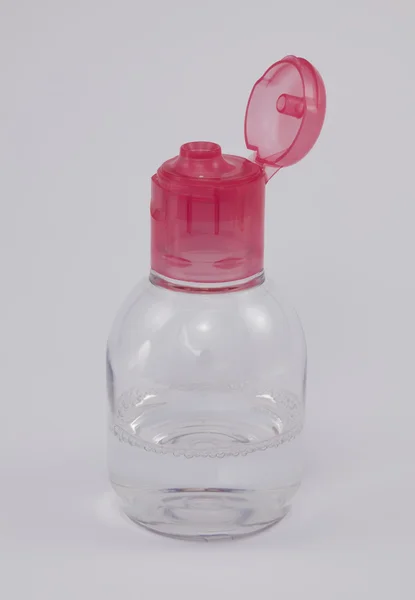 Transparent plastic jar with red cap on a white background. — Stock Photo, Image