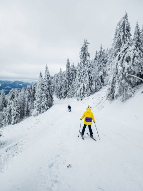skier walking down the snow on a ski slope