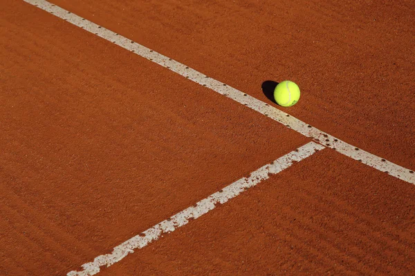 Kırmızı tenis kortunda tenis topu