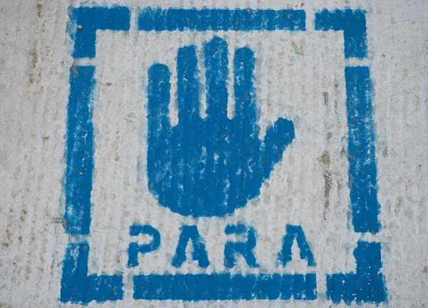 Pedestrian sign on the ground of the road that indicates stop. Sign on the asphalt for indications to pedestrians. Prevent accidents.