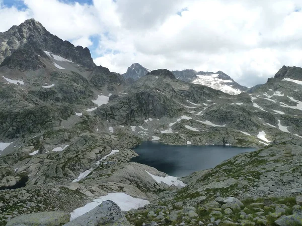 Semi-snowy mountain landscape on Lake Artouste, Pyrenees. Perpetual snow.