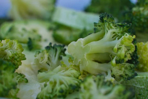 Detail of steamed broccoli flowers on unfocused background. Healthy and low calorie food concept.
