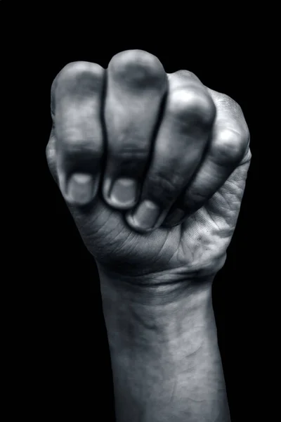 clenched fist isolated on black background