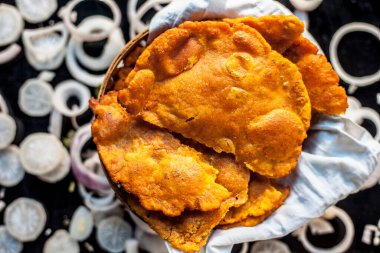 Siyah bir yüzey üzerinde bir konteynırda taze püre Hint yemeği yakın çekim.