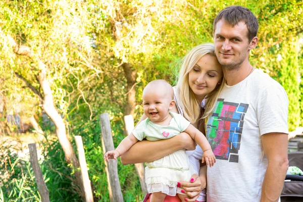 Happy young family spending time outdoors on a summer day.