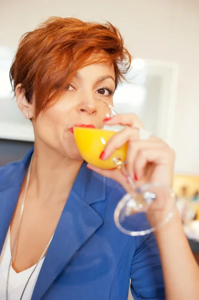 Smiling young woman drinking fresh fruits — Stock Photo, Image