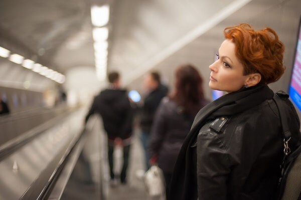 Woman in the metro escalator tounel