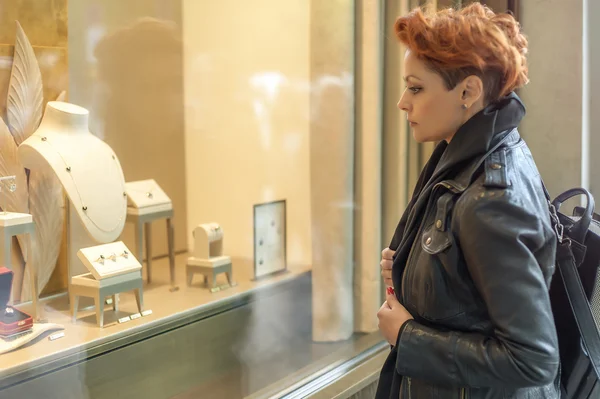 Женщина смотрит в витрину магазина с драгоценностями — стоковое фото