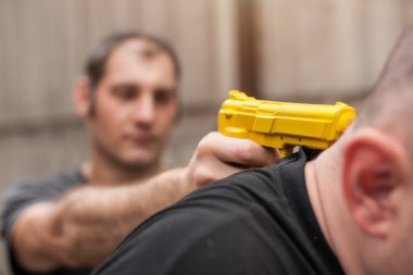 Gun Disarm. Self defense techniques against a gun point. clipart
