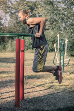 Açık havada eğitim. Pazı ve triceps şeyleri yaparak eğitim dips.