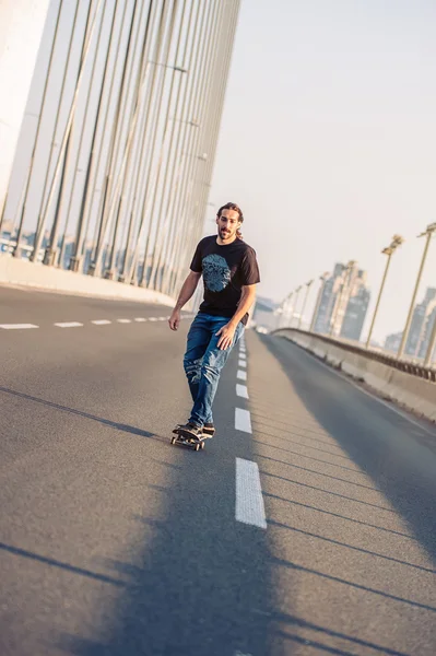 Skateboarder fährt mit Skate über eine Straßenbrücke in der Stadt — Stockfoto