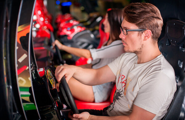 Man playing driving wheel video game