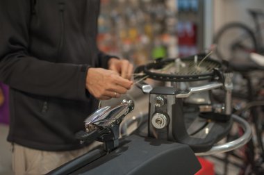 Close up of tennis stringer hands doing racket stringing clipart