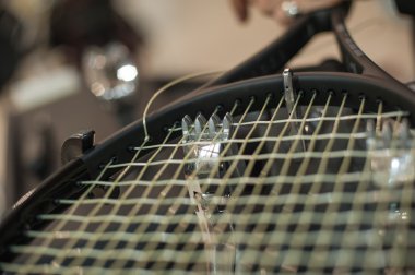 Detail of tennis racket in the stringing machine clipart