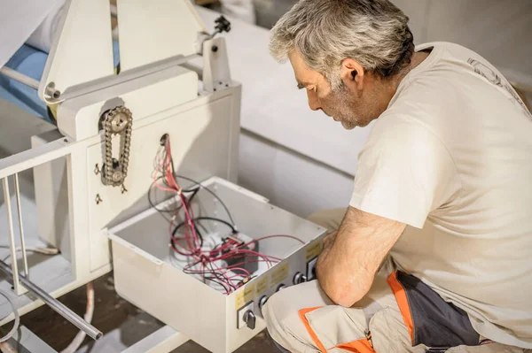 Close up of electrician engineer works with electric cable wires. Installation inspect. Electrical equipment