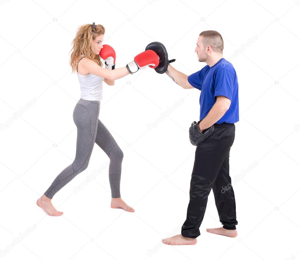 Kickboxing girl with trainer in sparring