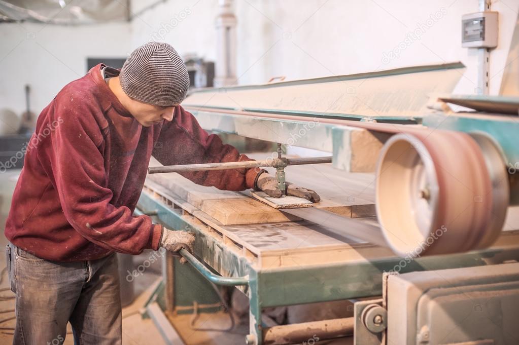 Carpenter using belt sander