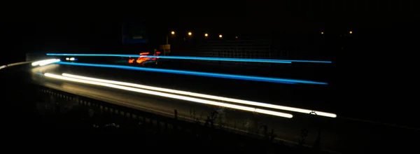 Night road lights. Lights of moving cars at night. long exposure multicolored