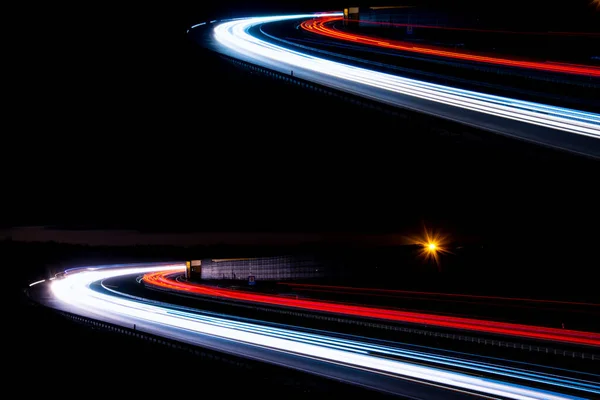 Night road lights. Lights of moving cars at night. long exposure red, blue, green