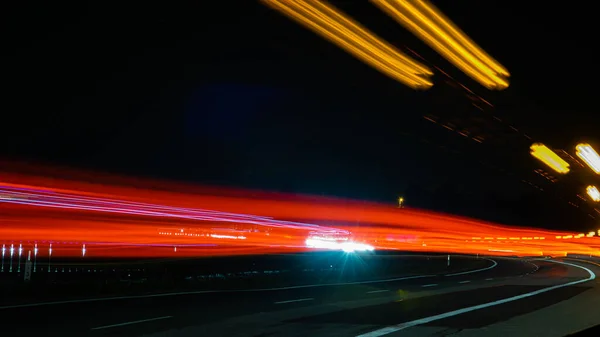 Night road lights. Lights of moving cars at night. long exposure red, blue, green