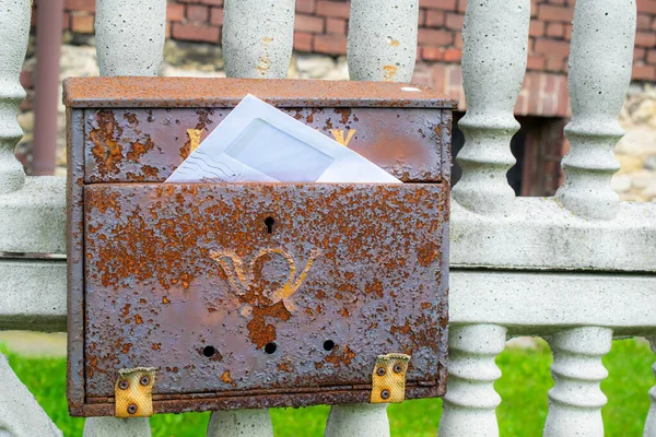 old backyard mailbox on the fence