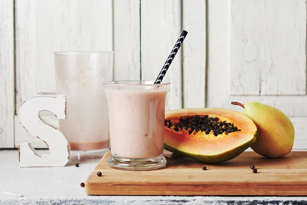 Fruit smoothie with papaya and pear. Healthy food concept.