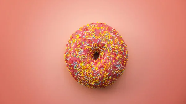 Pembe arka plan minimalist renklerine izole edilmiş pembe renkli ve serpiştirilmiş donutlar.
