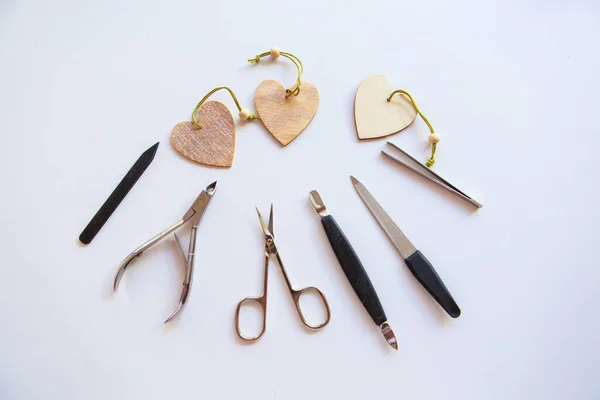 Nail accessories and hearts for Valentine\'s Day. Purchase of manicure products. manicure set for February 14. Visiting a beauty salon during the holidays. isolated on a white background