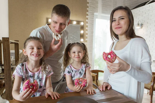 the family eats cakes. dinner at the bakery. feast in the kitchen. the butchering of the food.