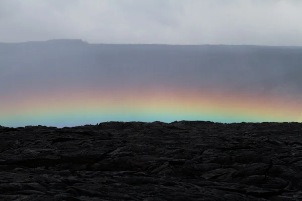 Rainbow over a lava field — Stock Photo, Image