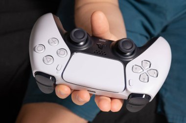 Boy with Playstation 5 controller in your hands - 25th, November, 2020, Sao Paulo, Brazil clipart