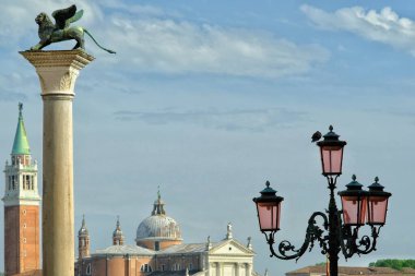 View of the roofs of buildings and the sculpture of a lion in Venice