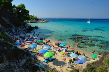 Chalkidiki, Greece - August 14, 2017: Tourists enjoying an amazing beautiful beach with turquoise waters in Chalkidiki Greece