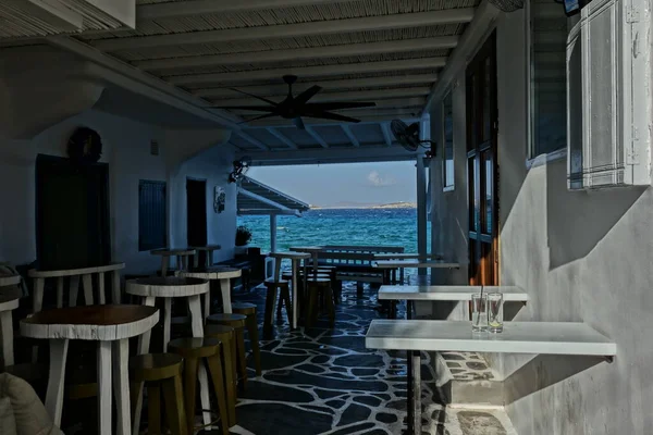An empty traditional outdoor bar with a view on the aegean sea in Mykonos Cyclades Greece