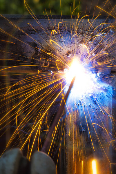 Welding sparks close up. Work welding machine. Metalwork.