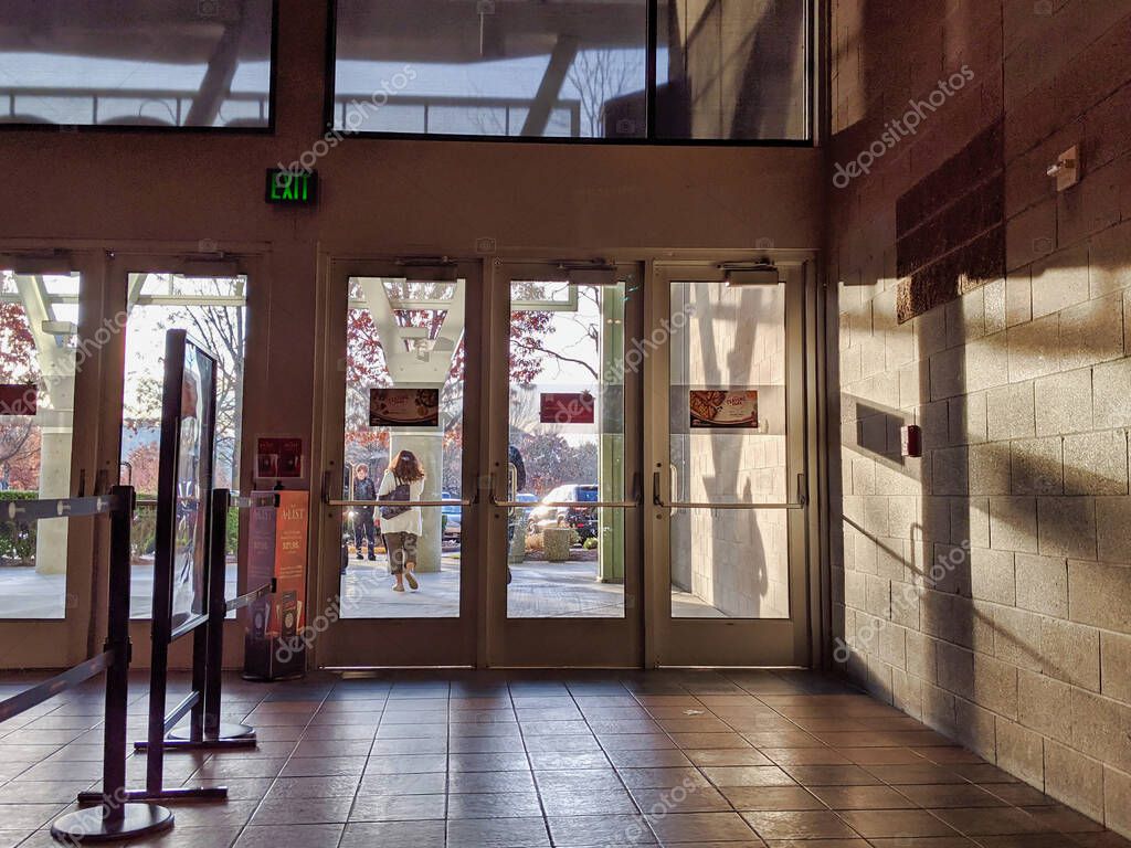 Woodinville, WA / USA - November 2nd, 2019: AMC movie theater exit doors next to the entrance foyer for ticket purchasing.
