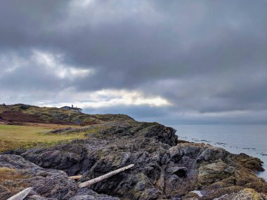 San Juan Adası kayalık sahilinin nefes kesici manzarası. Limanın üzerinde yuvarlanan, bulutlu bulutlar.