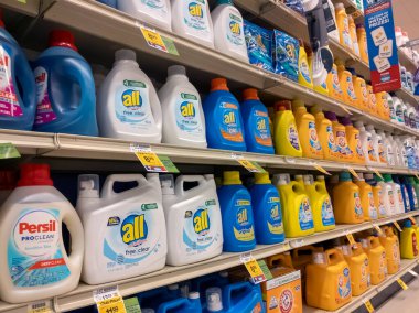 Kirkland, WA USA - circa March 2021: Angled view of a laundry detergent aisle inside a Safeway grocery store. clipart