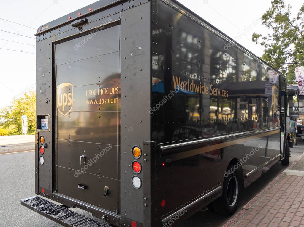 Tacoma, WA USA - circa August 2021: View of a brown UPS delivery truck parked on the side of a street downtown.