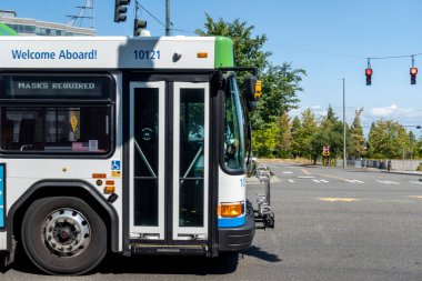 Tacoma, WA USA - circa August 2021: Street view of a Pierce Transit metro bus making its route downtown, heading toward Federal Way. clipart