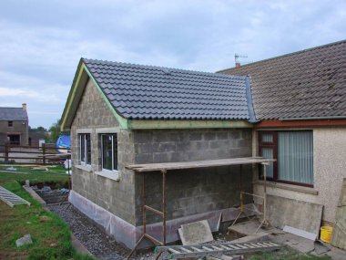 Building an Extension on to a bungalow house home including roof clipart
