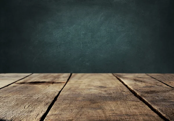 Wood table with blackboard background — Stock Photo, Image