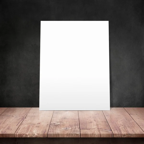 White poster on a wooden table — Stock Photo, Image