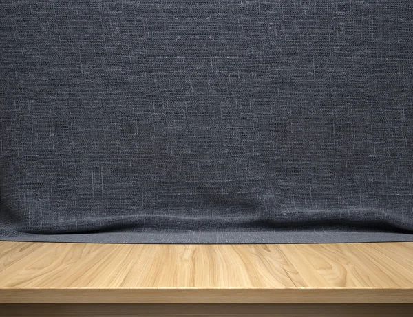 Houten tafel met donker blauw katoen weefsel achtergrond — Stockfoto